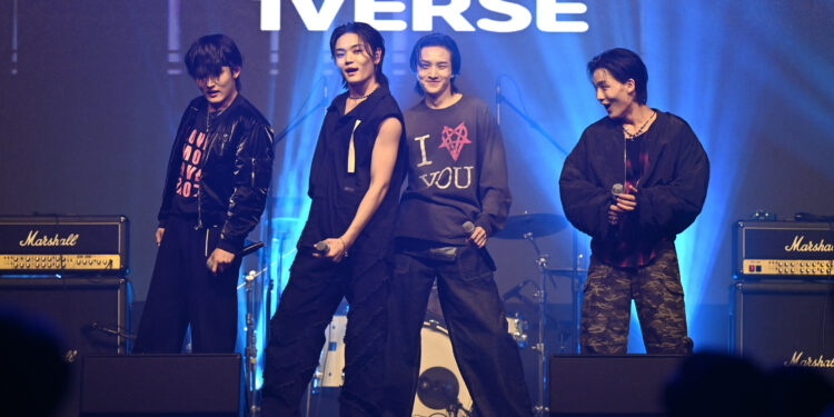 This picture taken on November 25, 2024 shows K-pop group 1Verse members (L-R) Seok, Aito, Kenny and Hyuk performing during a music festival in Suwon. 1Verse is a new five-member K-pop band: Chinese-American Kenny, Aito from Japan, Lao-Thai American Nathan, and Seok and Hyuk from North Korea who defected to the South. (Photo by Jung Yeon-je / AFP) / TO GO WITH AFP STORY SKorea-NKorea-defector-kpop, FOCUS  BY Hieun SHIN (Photo by JUNG YEON-JE/AFP via Getty Images)