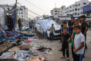 Palestinians stand near the destroyed Al Jazeera tent at Al-Shifa Hospital in Gaza City on August 11, 2025, following an overnight strike by the Israeli military. Bashar Taleb/AFP/Getty Images