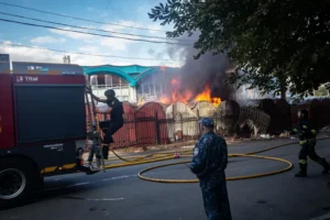 Emergency services workers extinguish a fire, causeed by the explosion of a Russian drone, at the central market in Sumy, Ukraine, earlier in the day on Friday. Francisco Richart Barbeira/NurPhoto/Getty Images